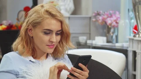 The girl is looking at something in her mobile phone Stock Footage