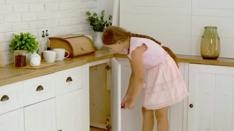 The girl is looking for something in the kitchen Stock Footage 159219575