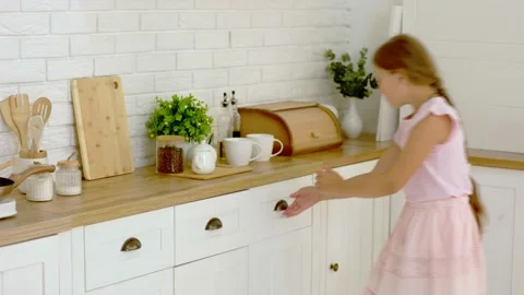 The girl is looking for something in the kitchen Stock Footage 159470274