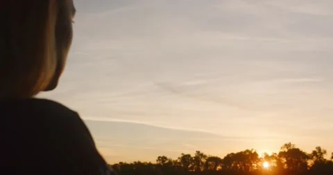 Girl looking at the sunset Stock Footage 202093398
