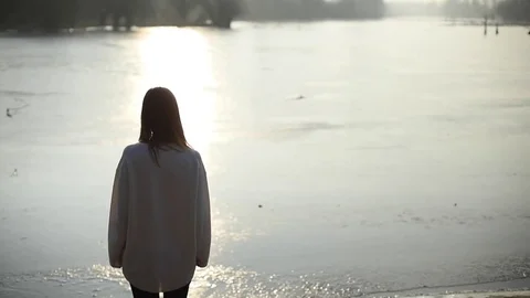 Girl looking at sunset on a river Stock-Footage 72693041