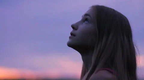 Girl looking up to sunset sky with hope pray prayer HD Stock Footage