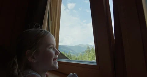 Girl looking through train window at mountain landscape Stock Footage 340791858