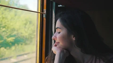 Girl is looking in the window from the train Stock Footage 76250077