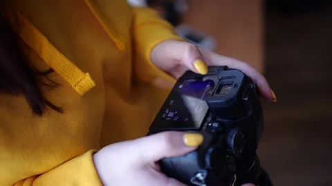 The girl looks at the frames on the camera Stock Footage 126994716