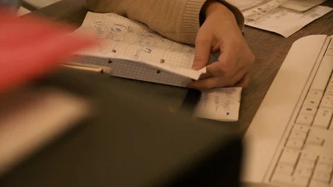 The girl looks in a notebook at the table. In a notebook looks information. Stock Footage 125418882