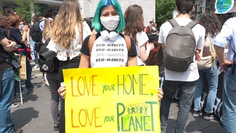 Girl with "LOVE PLANET" picket sign and pollution mask, Friday for future, Milan Stock Footage