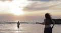 girl in love runs to her boyfriend into the sea - hugs and kisses - sunset HD Footage