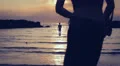 girl in love runs to her boyfriend into the sea - hugs and kisses - sunset HD Footage