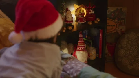 Girl lying on bed and looking at Christmas toys Stock Footage 265425396