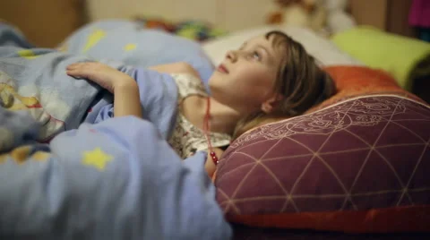The girl is lying in bed before going to sleep Stock Footage 60351402