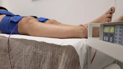 Girl lying on bed receiving electrostimulation therapy at beauty salon. Stock Footage 227355538
