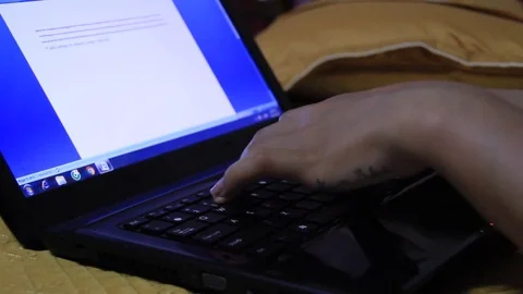 Girl lying in bed text editor on your computer Stock Footage 70738468