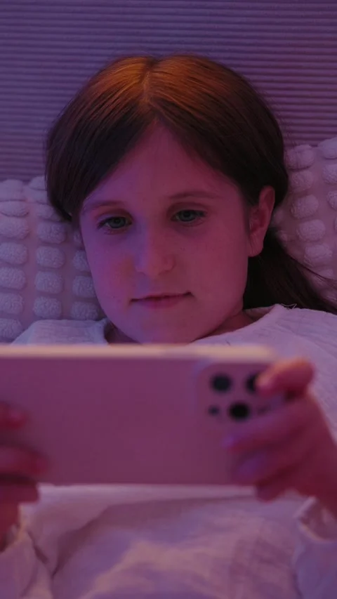 Girl Lying in Bed Using Smartphone at Night Stock Footage 345528417