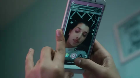 Girl lying down and using her smartphone indoors Stock Footage 275012063
