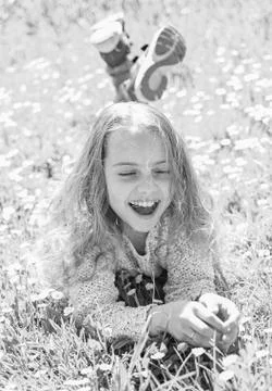Girl lying on grass, grassplot on background. Child enjoy spring sunny weather Stock Photos