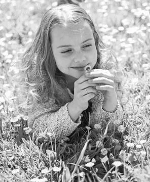 Girl lying on grass, grassplot on background. Sensitivity concept. Child enjoy Stock Photos