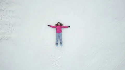 Girl lying in the snow Stock Footage 55280480