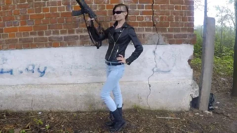 Girl with machinegun Stock Footage 69229279