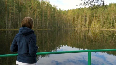Girl make a picture using phone in the forest Stock Footage