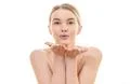 The girl makes an air kiss on the white background Photo