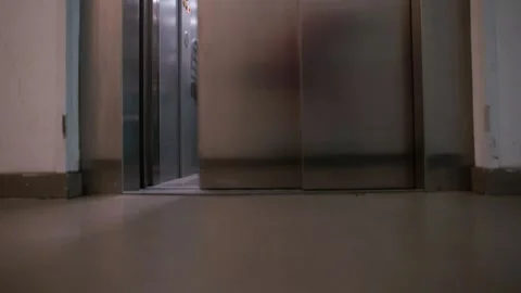 The girl makes dance moves in the elevator with doors opening and closing. Stock Footage 136822028