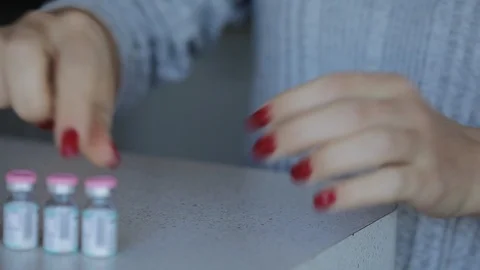 Girl makes a difficult injection solution at home Stock Footage 122223315