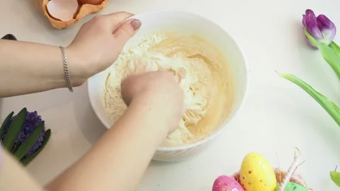 Girl makes a easter biscuit cake in the kitchen. for the Easter holiday Stockbeeldmateriaal 150793946