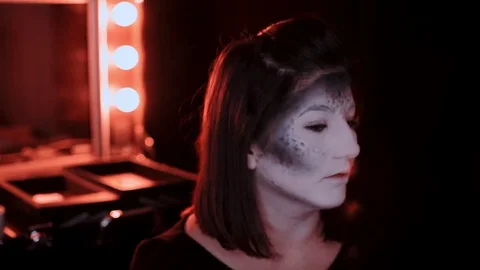 Girl makes a make-up in the style of a witch Halloween Stock Footage 69206750