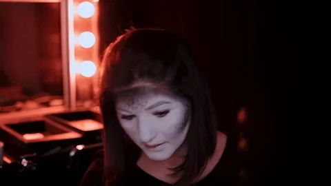 Girl makes a make-up in the style of a witch Halloween Stock Footage 69206781