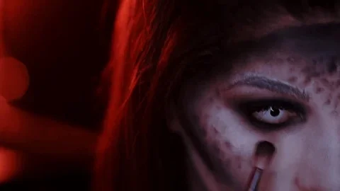 Girl makes a make-up in the style of a witch Halloween Stock Footage 69206784