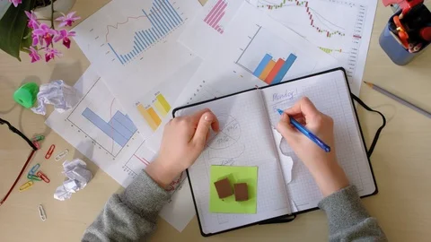 Girl makes notes in a notebook, gets angry and tears out pages. Top view. Stock Footage 94047415