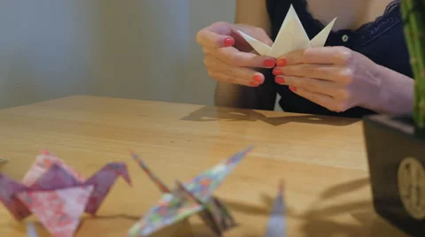 Girl Makes Paper Crane Origami From Yellow Paper - Cinema 4K Stock Footage 61105853