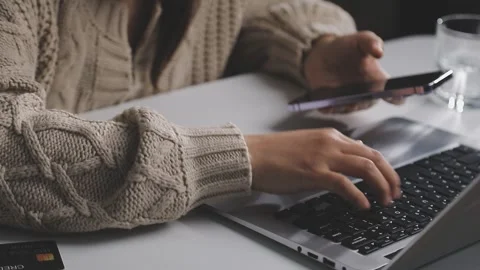 Girl makes a purchase on the Internet on the computer with credit card Stock Footage 313583821