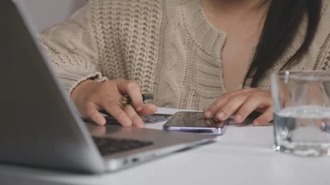 Girl makes a purchase on the Internet on the computer with credit card Stock Footage 313583822