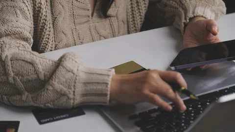 Girl makes a purchase on the Internet on the computer with credit card Stock Footage 313583858
