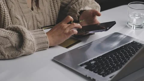 Girl makes a purchase on the Internet on the computer with credit card Stock Footage 313583875