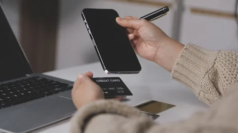 Girl makes a purchase on the Internet on the computer with credit card Stock Footage 313583947