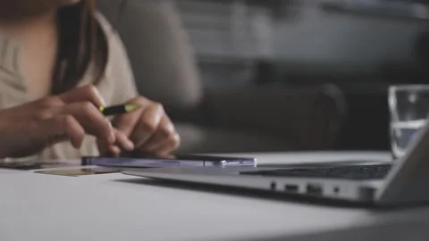 Girl makes a purchase on the Internet on the computer with credit card Stock Footage 313583953