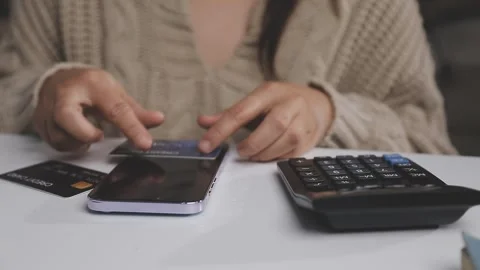 Girl makes a purchase on the Internet on the computer with credit card Stock Footage 313583955