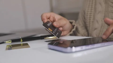 Girl makes a purchase on the Internet on the computer with credit card Stock Footage 313583969
