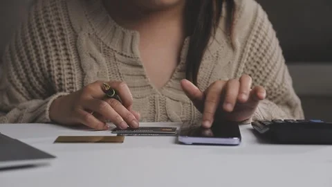 Girl makes a purchase on the Internet on the computer with credit card Stock Footage 313583973