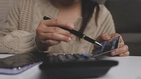 Girl makes a purchase on the Internet on the computer with credit card Stock Footage 313584035
