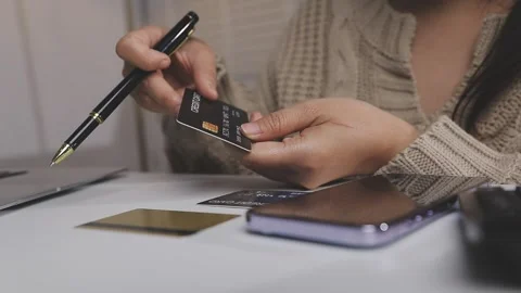Girl makes a purchase on the Internet on the computer with credit card Stock Footage 313584050