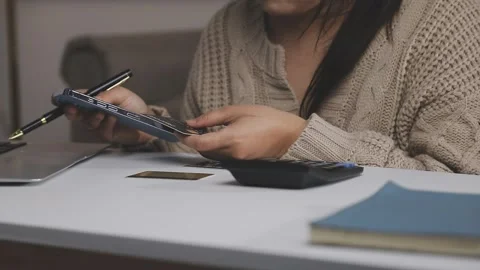 Girl makes a purchase on the Internet on the computer with credit card Stock Footage 313584151