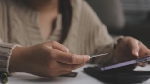 Girl makes a purchase on the Internet on the computer with credit card Stock Footage 313584205