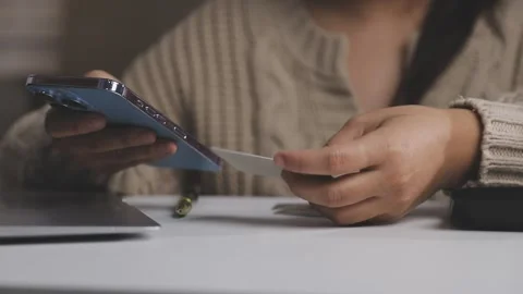 Girl makes a purchase on the Internet on the computer with credit card Stock Footage 313584228