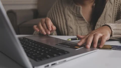 Girl makes a purchase on the Internet on the computer with credit card Stock Footage 313584254