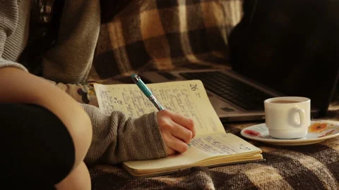 The girl makes a record in the diary Stock Footage 94057118