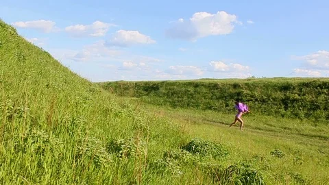 The girl makes tricks dancing against the background of nature. Stock Footage 76189081
